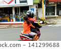 A person on a motorcycle rides a scenic asphalt road in Asia 141299688