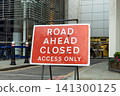 Road ahead closed access only sign on city street 141300125