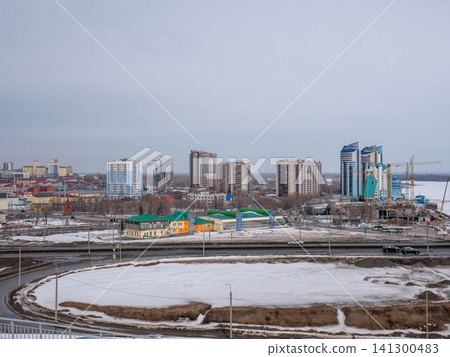 March 22 2026 Barnaul Russia aerial view of Bavarin Square and River Station covered in snow cold early spring cityscape urban architecture and winter atmosphere. March 22 2026 Barnaul Russia aerial view of Bavarin Square and River Station covered in snow cold early spring cityscape urban architecture and winter atmosphere. 141300483