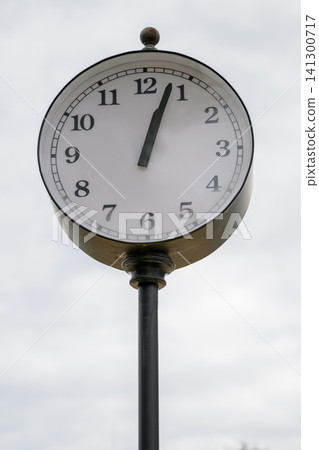 Old-fashioned clock mounted on a pole Old-fashioned clock mounted on a pole 141300717