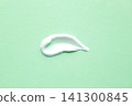 White cosmetic cream smear on mint green background for skincare and beauty product texture 141300845