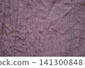 Wrinkled purple fabric texture close-up with subtle weave and natural creases for background 141300848