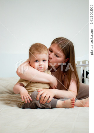 Close up of mother and son exchanging loving hugs and giggles. Perfect illustration of secure attachment and childhood happiness Close up of mother and son exchanging loving hugs and giggles. Perfect illustration of secure attachment and childhood happiness 141301003
