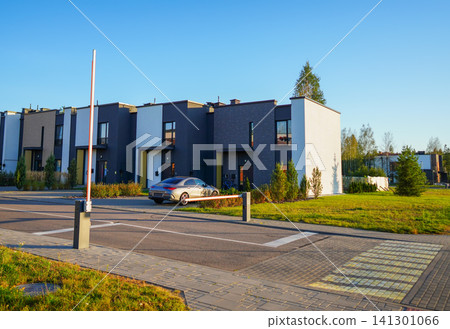 Automatic car barrier in Private urbanization residential area. Townhouses in Gated community Automatic car barrier in Private urbanization residential area. Townhouses in Gated community 141301066