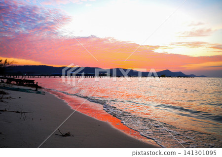Sunset view over beach with calm sea waves and distant hills on Phu Quoc Island, Vietnam Sunset view over beach with calm sea waves and distant hills on Phu Quoc Island, Vietnam 141301095