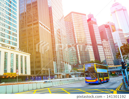 City traffic in Central Business District of Hong Kong. Red taxis and double-decker buses on road 141301192
