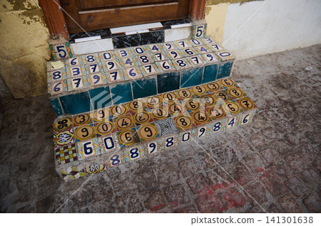 Colorful tiled numbered steps at a doorway in the old Medina of Essaouira, Morocco Colorful tiled numbered steps at a doorway in the old Medina of Essaouira, Morocco 141301638