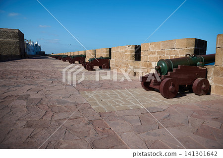 Row of historic cannons on the Skala sea wall in Essaouira, Morocco medina promenade Row of historic cannons on the Skala sea wall in Essaouira, Morocco medina promenade 141301642