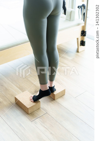 Yoga block exercise stretch for feet Yoga block exercise stretch for feet 141302302