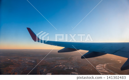 View from the airplane window during taking off on a clear summer morning View from the airplane window during taking off on a clear summer morning 141302483