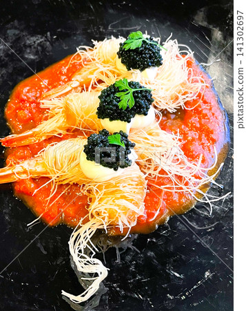 Black tiger shrimp fried in kataifi pastry, topped with caviar. Black tiger shrimp fried in kataifi pastry, topped with caviar. 141302697
