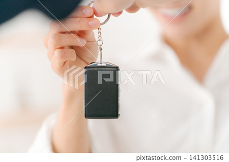 Woman receiving car keys Woman receiving car keys 141303516
