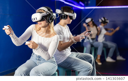 Guy and girl playing against another couple in a game Guy and girl playing against another couple in a game 141303607