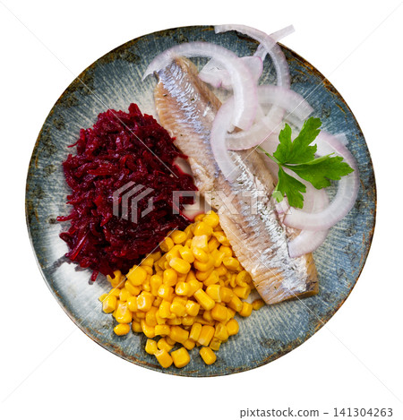 Herring served on plate with grated beetroot and corn 141304263