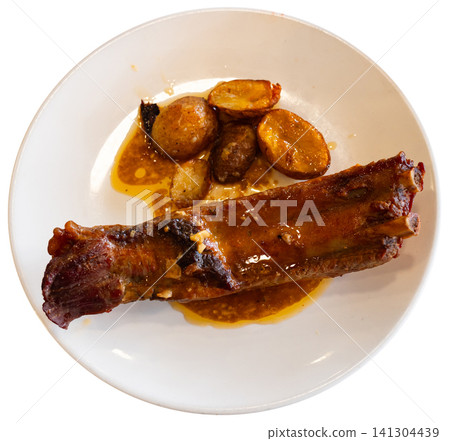 Fried pork ribs served with potatoes on plate Fried pork ribs served with potatoes on plate 141304439