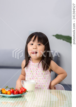 Playful Asian little girl making funny face while eating, child behavior and emotional expression concept Playful Asian little girl making funny face while eating, child behavior and emotional expression concept 141304527