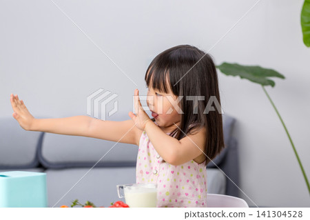 Unhappy Asian little girl refusing to eat vegetables, picky eating and child behavior concept 141304528