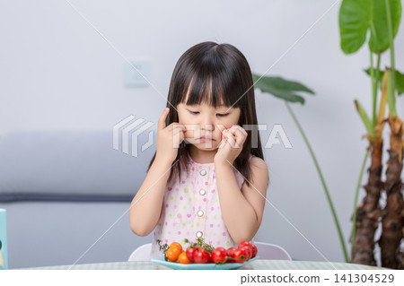 Unhappy Asian little girl refusing to eat vegetables, picky eating and child behavior concept Unhappy Asian little girl refusing to eat vegetables, picky eating and child behavior concept 141304529