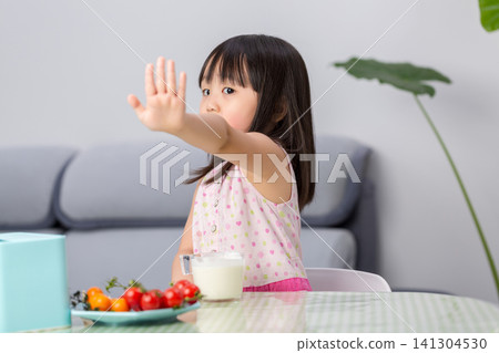 Unhappy Asian little girl refusing to eat vegetables, picky eating and child behavior concept Unhappy Asian little girl refusing to eat vegetables, picky eating and child behavior concept 141304530