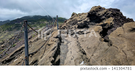 A walk along the edge of the crater of the San Antonio volcano on the Canary Island of La Palma along the tourist trail. High quality photo A walk along the edge of the crater of the San Antonio volcano on the Canary Island of La Palma along the tourist trail. High quality photo 141304781