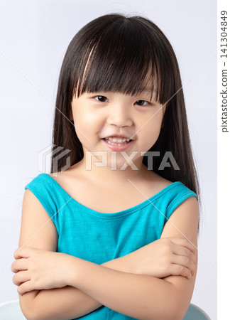 Confident little Asian girl standing with arms crossed, smiling and proud child portrait. 141304849