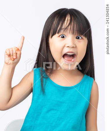 Happy Asian girl pointing finger up having a great idea, eureka moment or discovery concept. 141304854