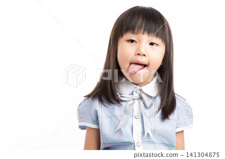 Playful little Asian girl sticking her tongue out, making a funny face, white background. Playful little Asian girl sticking her tongue out, making a funny face, white background. 141304875