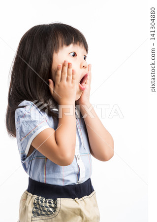 Furious little girl screaming loudly with hands up, concept of losing control and anger. Furious little girl screaming loudly with hands up, concept of losing control and anger. 141304880