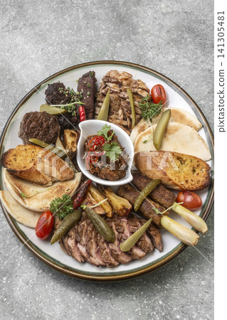 mixed grilled meat bbq gourmet big plate on restaurant table mixed grilled meat bbq gourmet big plate on restaurant table 141305481