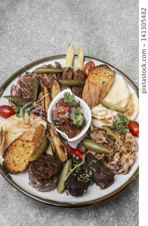 mixed grilled meat bbq gourmet big plate on restaurant table mixed grilled meat bbq gourmet big plate on restaurant table 141305482