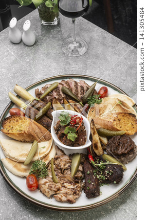 mixed grilled meat bbq gourmet big plate on restaurant table mixed grilled meat bbq gourmet big plate on restaurant table 141305484