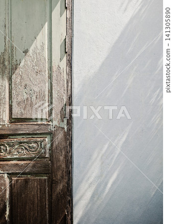 Rustic Old Wooden Door with Peeling Mint Green Paint and Soft Leaf Shadow on White Wall Background Rustic Old Wooden Door with Peeling Mint Green Paint and Soft Leaf Shadow on White Wall Background 141305890