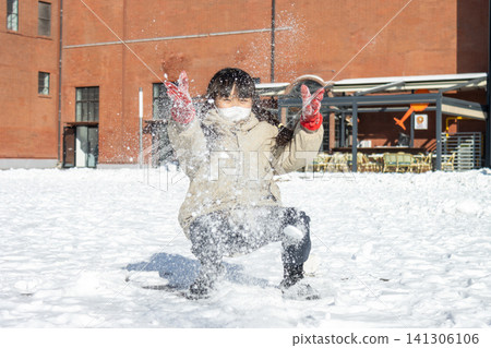 Happy Asian Child Playing in Snow Winter Outdoor, Cute Girl Making Snowball and Snowman, Joyful Cold Weather Lifestyle Happy Asian Child Playing in Snow Winter Outdoor, Cute Girl Making Snowball and Snowman, Joyful Cold Weather Lifestyle 141306106