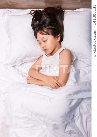 Asian little girl sleeping peacefully in bed, healthy sleep and childhood rest concept Asian little girl sleeping peacefully in bed, healthy sleep and childhood rest concept 141306133