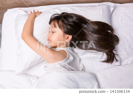 Asian little girl sleeping peacefully in bed, healthy sleep and childhood rest concept 141306134