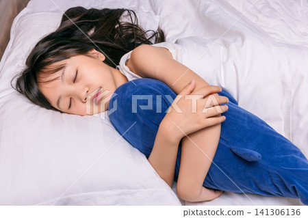 Asian little girl sleeping peacefully in bed, healthy sleep and childhood rest concept Asian little girl sleeping peacefully in bed, healthy sleep and childhood rest concept 141306136