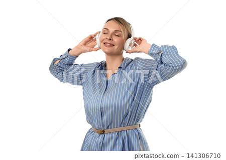 Woman smiles and listens to music with headphones, isolated on white, PNG Woman smiles and listens to music with headphones, isolated on white, PNG 141306710