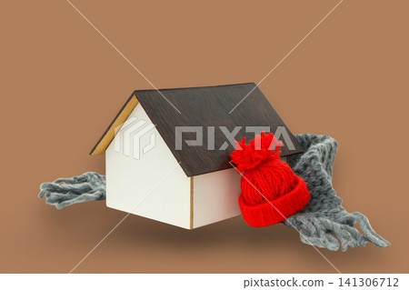 A tiny house dressed for winter with a hat and scarf 141306712