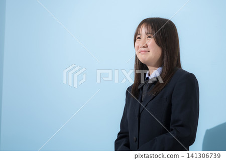 A light blue background with images of middle school and high school girls in uniforms standing and looking up with smiles. A light blue background with images of middle school and high school girls in uniforms standing and looking up with smiles. 141306739