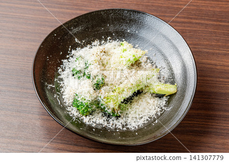 Roasted broccoli with gooey cheese Roasted broccoli with gooey cheese 141307779