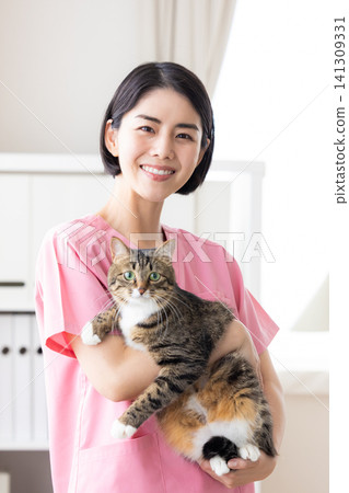 Veterinarian - Portrait of a veterinarian holding a cat Veterinarian - Portrait of a veterinarian holding a cat 141309331
