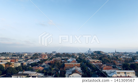 High angle panorama of a leafy green suburb in Melbourne stretching toward the distant metropolitan city skyline High angle panorama of a leafy green suburb in Melbourne stretching toward the distant metropolitan city skyline 141309567