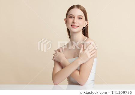 A beautiful young Asian woman with clean, fresh skin against a beige background. Skincare, facial treatment, cosmetology, beauty, and spa. An elegant portrait of an Asian woman. A beautiful young Asian woman with clean, fresh skin against a beige background. Skincare, facial treatment, cosmetology, beauty, and spa. An elegant portrait of an Asian woman. 141309756