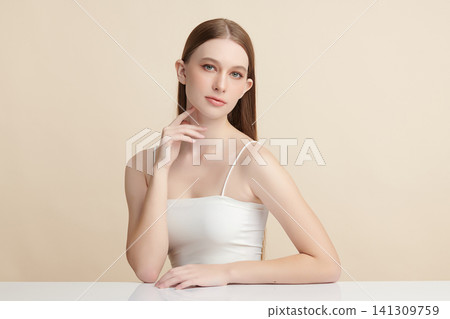 A beautiful young Asian woman with clean, fresh skin against a beige background. Skincare, facial treatment, cosmetology, beauty, and spa. An elegant portrait of an Asian woman. A beautiful young Asian woman with clean, fresh skin against a beige background. Skincare, facial treatment, cosmetology, beauty, and spa. An elegant portrait of an Asian woman. 141309759