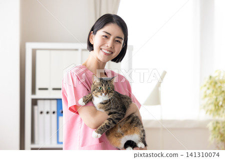 Veterinarian - Portrait of a veterinarian holding a cat 141310074