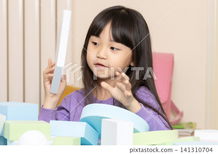 Asian little girl building tower with blocks at home, creative play and STEM learning concept Asian little girl building tower with blocks at home, creative play and STEM learning concept 141310704