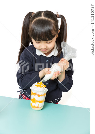 Asian school girl making fruit dessert with cream, DIY cooking and baking concept, child preparing healthy snack on white background Asian school girl making fruit dessert with cream, DIY cooking and baking concept, child preparing healthy snack on white background 141310757