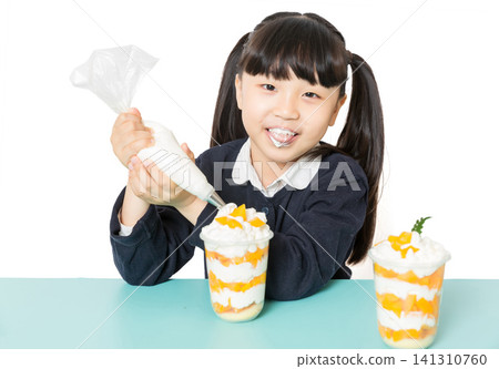 Asian school girl making fruit dessert with cream, DIY cooking and baking concept, child preparing healthy snack on white background Asian school girl making fruit dessert with cream, DIY cooking and baking concept, child preparing healthy snack on white background 141310760