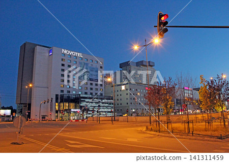 Novotel hotel building and city street at night in Lodz Poland Novotel hotel building and city street at night in Lodz Poland 141311459