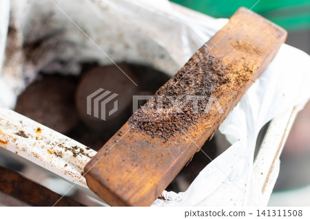 Fresh coffee grounds collected container for compost gardening natural soil enrichment Sustainable organic waste recycling for healthy plant growth 141311508
